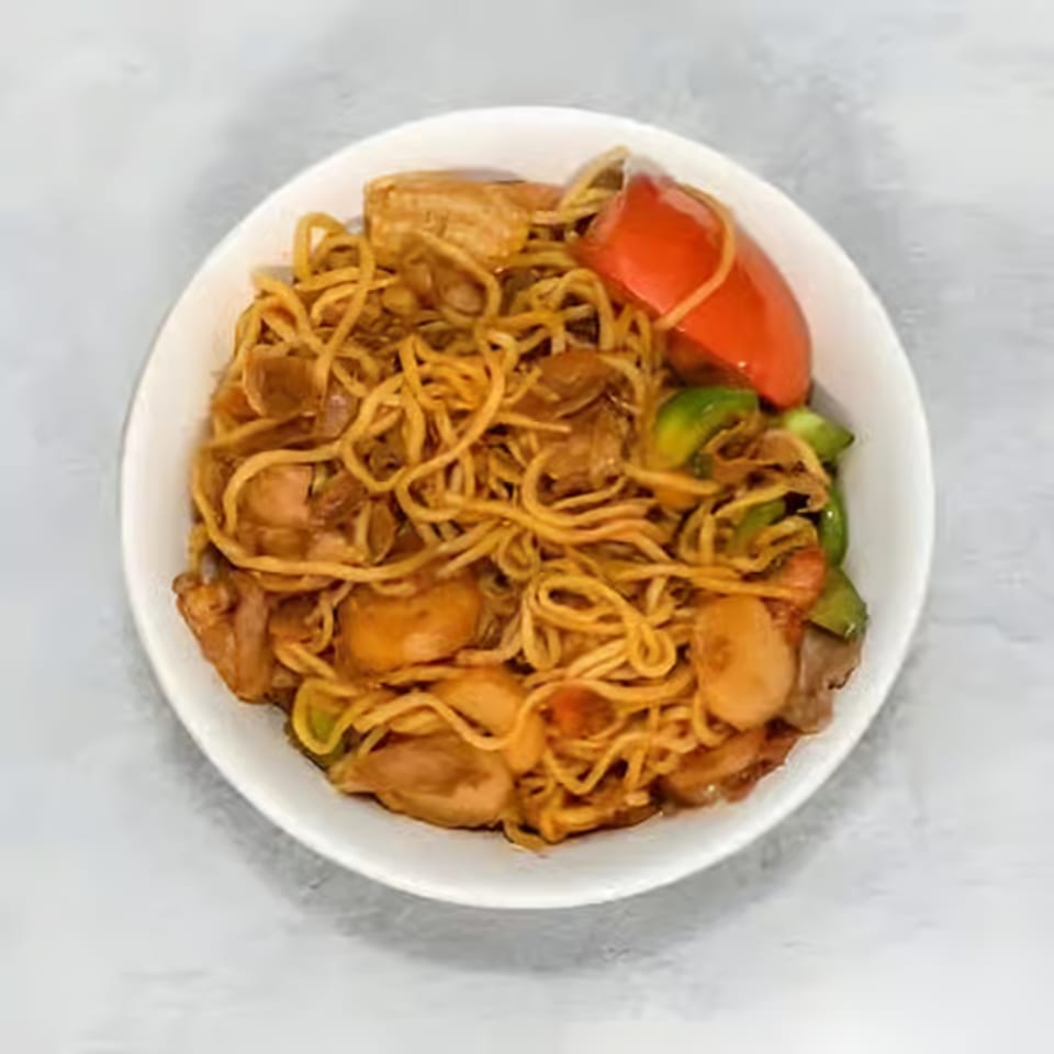 A white bowl filled with Hi Ho Mongolian Grill noodles, chicken, red and green bell peppers.