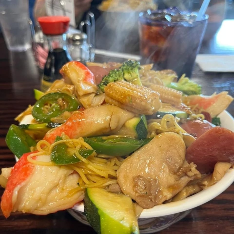 Steaming bowl of Hi Ho Mongolian Grill stir-fry with noodles, meats, and vegetables.